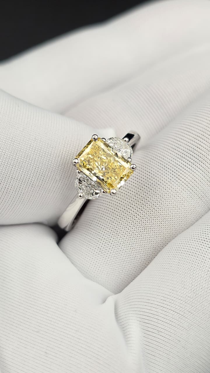Yellow diamond three-stone ring during a private jewellery consultation